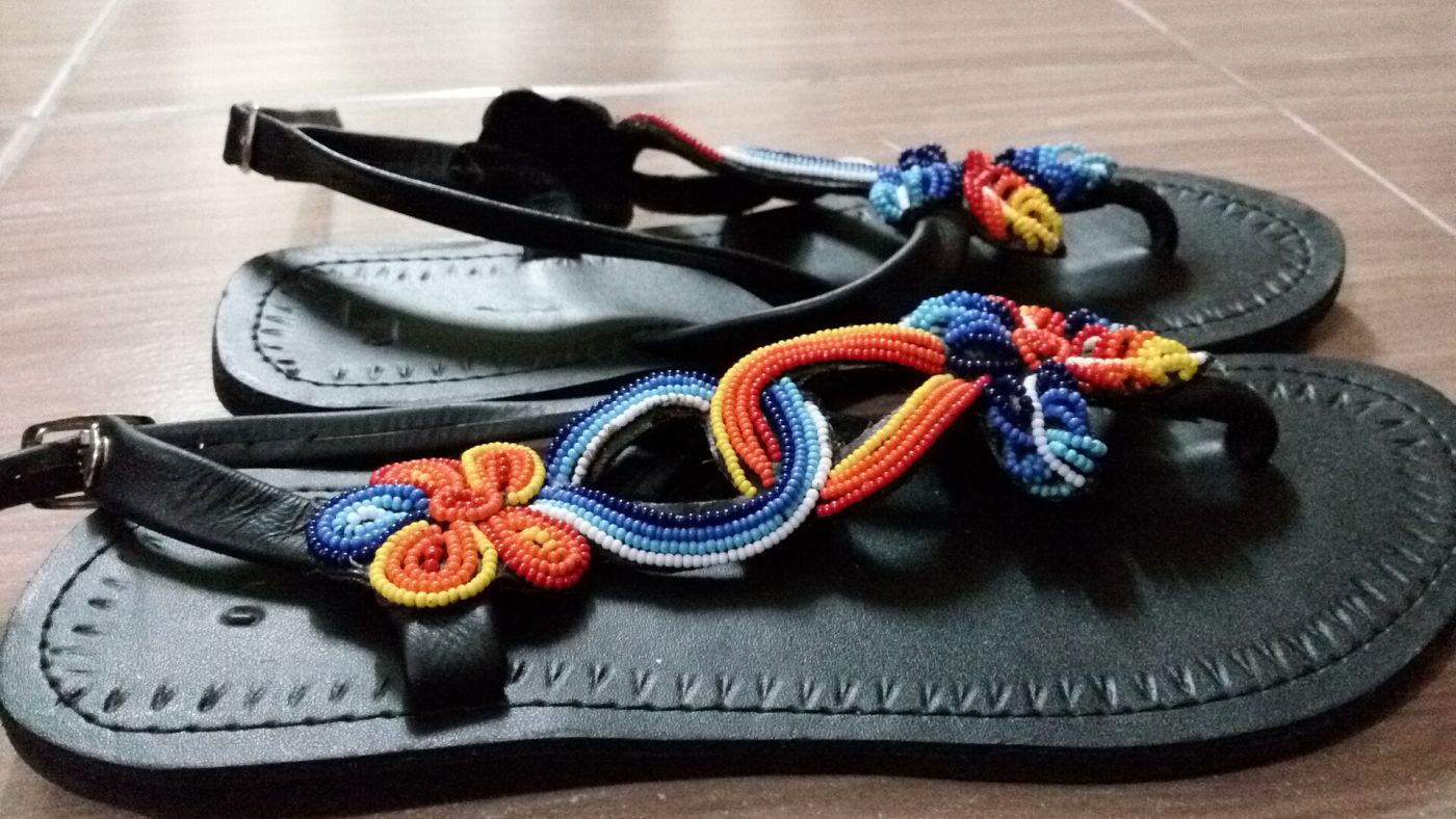 Pair of black leather sandals with colourful beaded straps